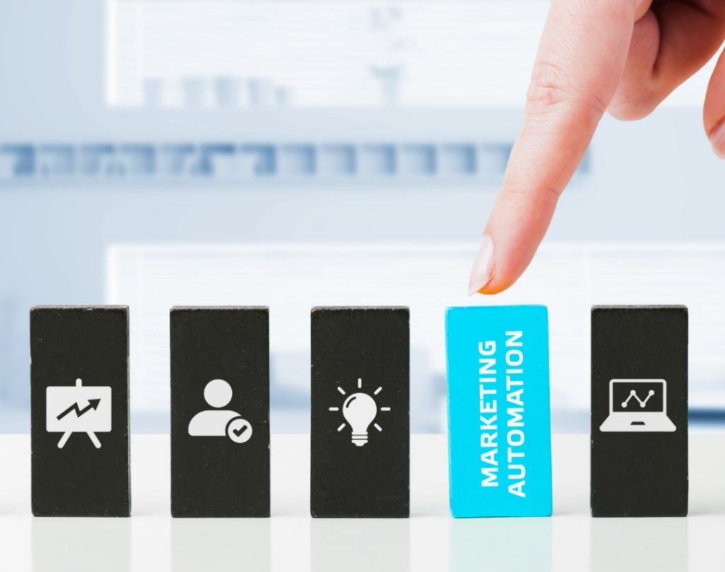 palec dotyka klocka z napisem marketing automation